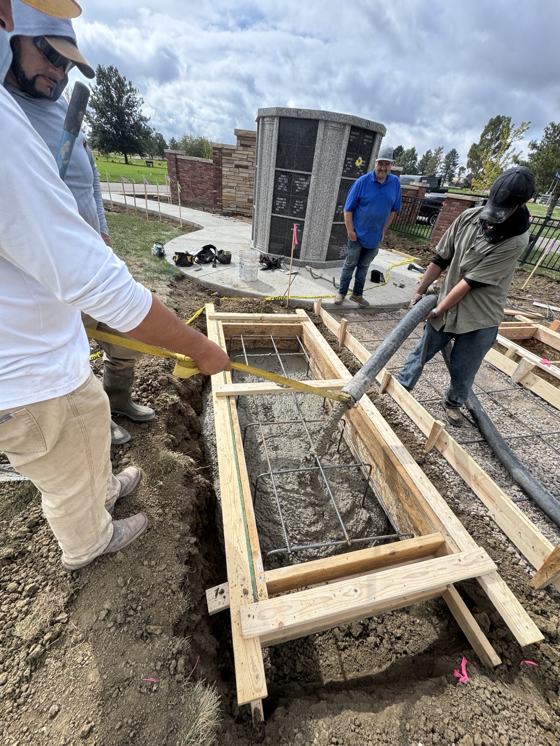 Crew placing concrete into prepared forms