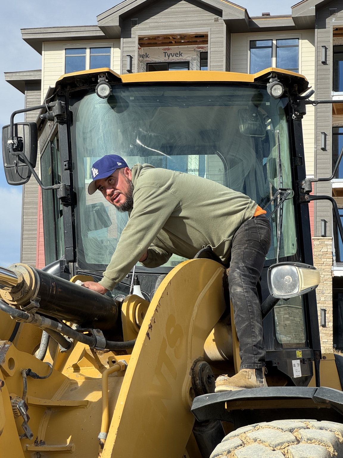 Crew member working with a compact loader