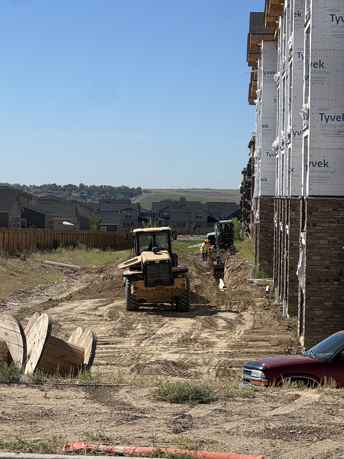Vaca crew preparing the ground beside a residential building